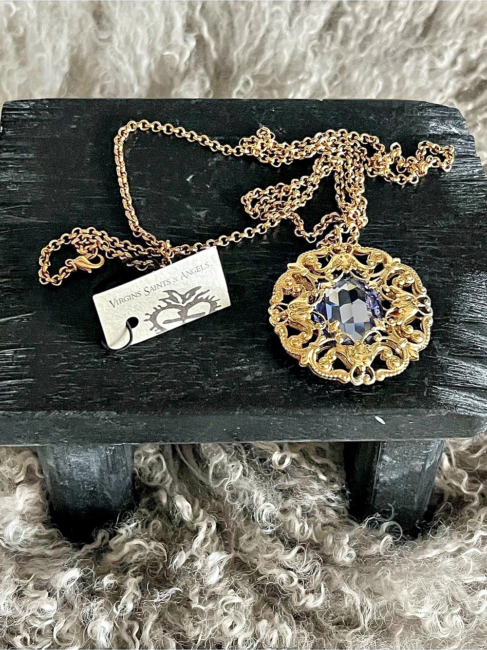 This is the ornate Virgins Saints & Angels Betty necklace with Purple Crystal.